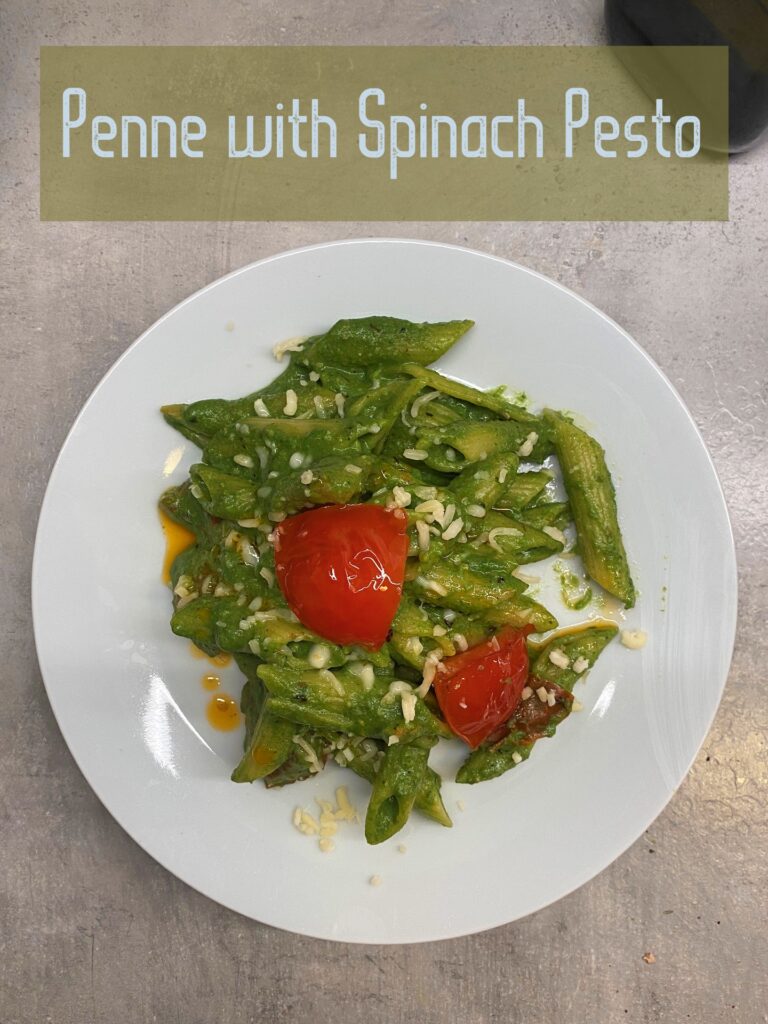 Top view displays contrasting Red and Green Penne with Spinach Pesto  